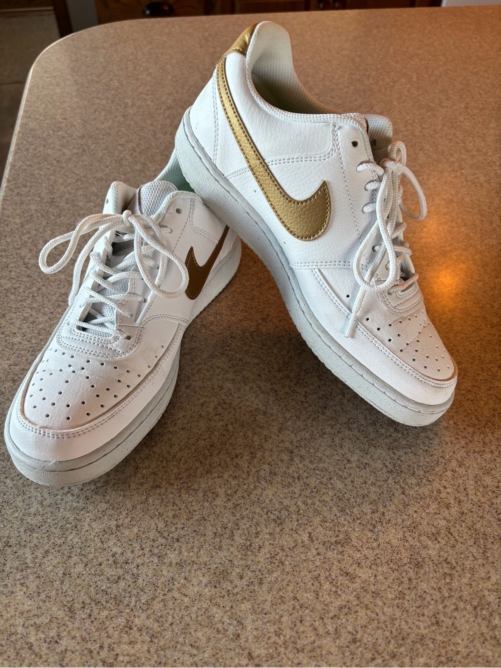 Nike Women’s White Sneakers with Gold Swoosh Accent